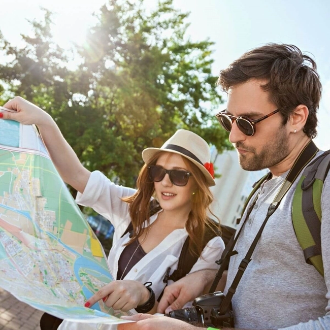 A woman and a man consult a world map