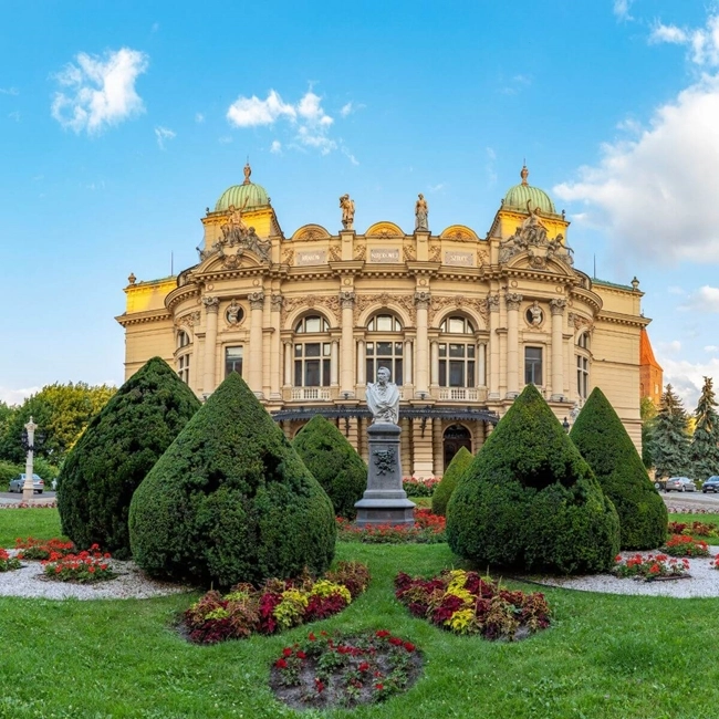 Opera House in Zagreb, Croatia, with elegant architecture and artistic details, illuminated under a blue sky.