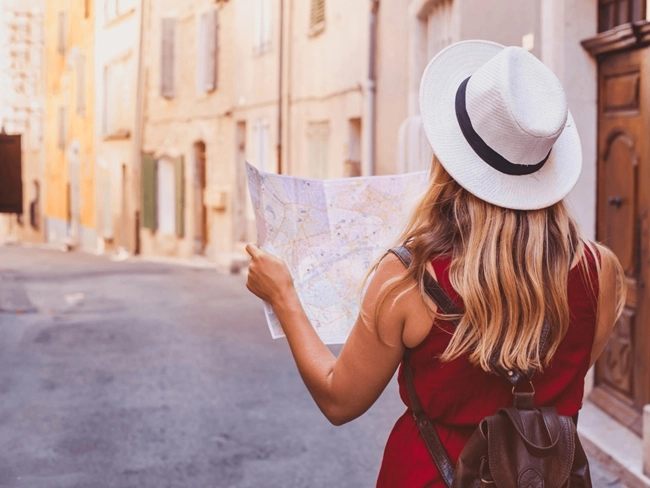 Woman with a hat holding a map