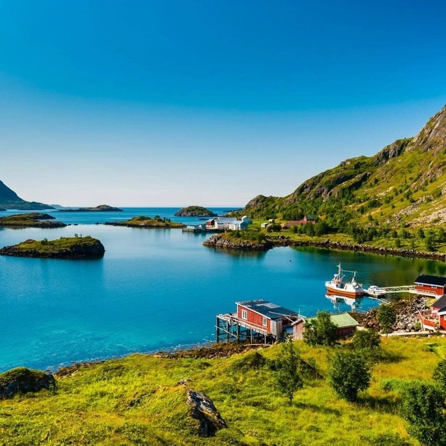 Magnificent Norwegian coastline with boats moored in the water, offering a serene and picturesque landscape.