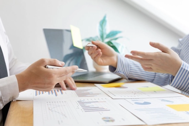 Two people talking around a table, exchanging ideas and opinions on a common subject.