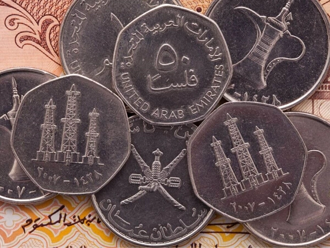 Close-up of several coins featuring Arabic script, highlighting their design and culture.