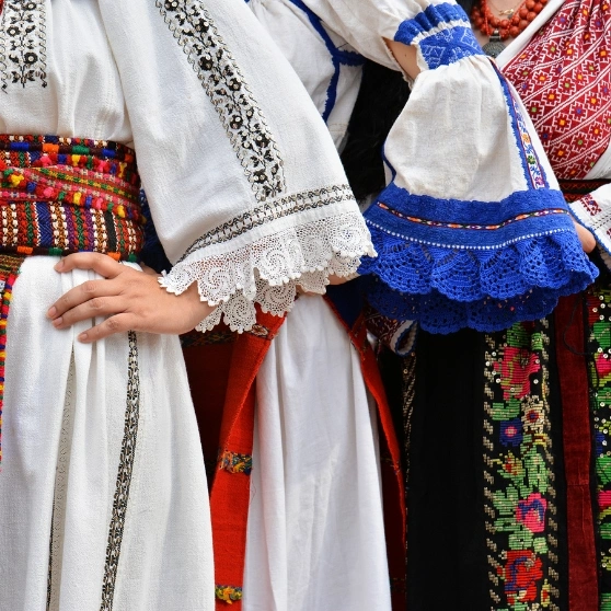 A woman taking a selfie while wearing a hat, smiling and capturing a moment of joy.