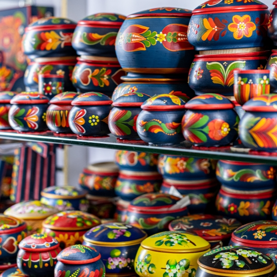 A woman taking a selfie while wearing a hat, smiling and capturing a moment of joy.
