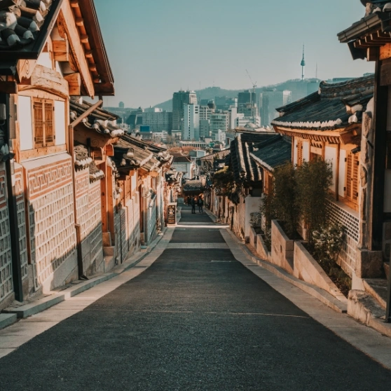 A woman taking a selfie while wearing a hat, smiling and capturing a moment of joy.