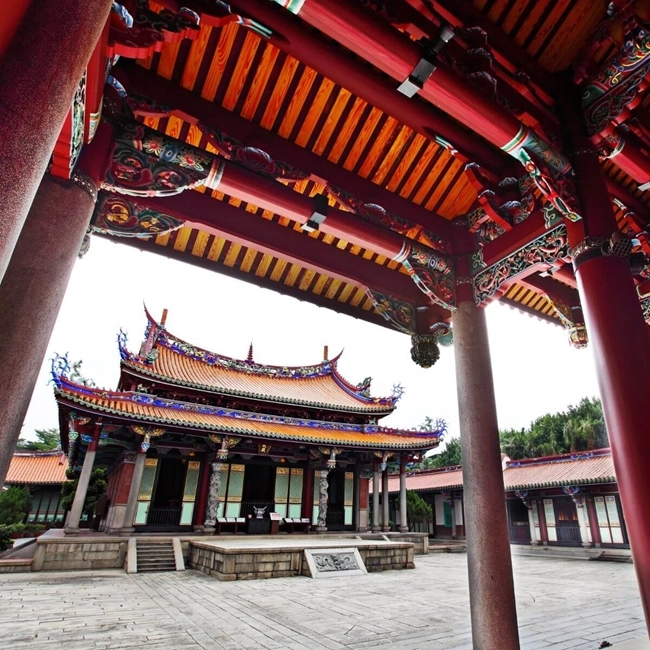 Buddhist temple in Taiwan, with traditional architecture and ornate details, surrounded by peaceful greenery.