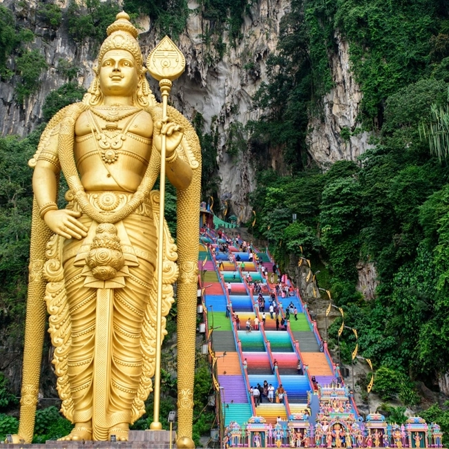 Large statue of Lord Ganesha in front of a majestic mountain, symbolizing spirituality and the power of nature.