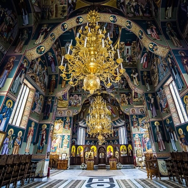  Interior of a church with a gold chandelier illuminating the sacred space and creating a warm atmosphere.