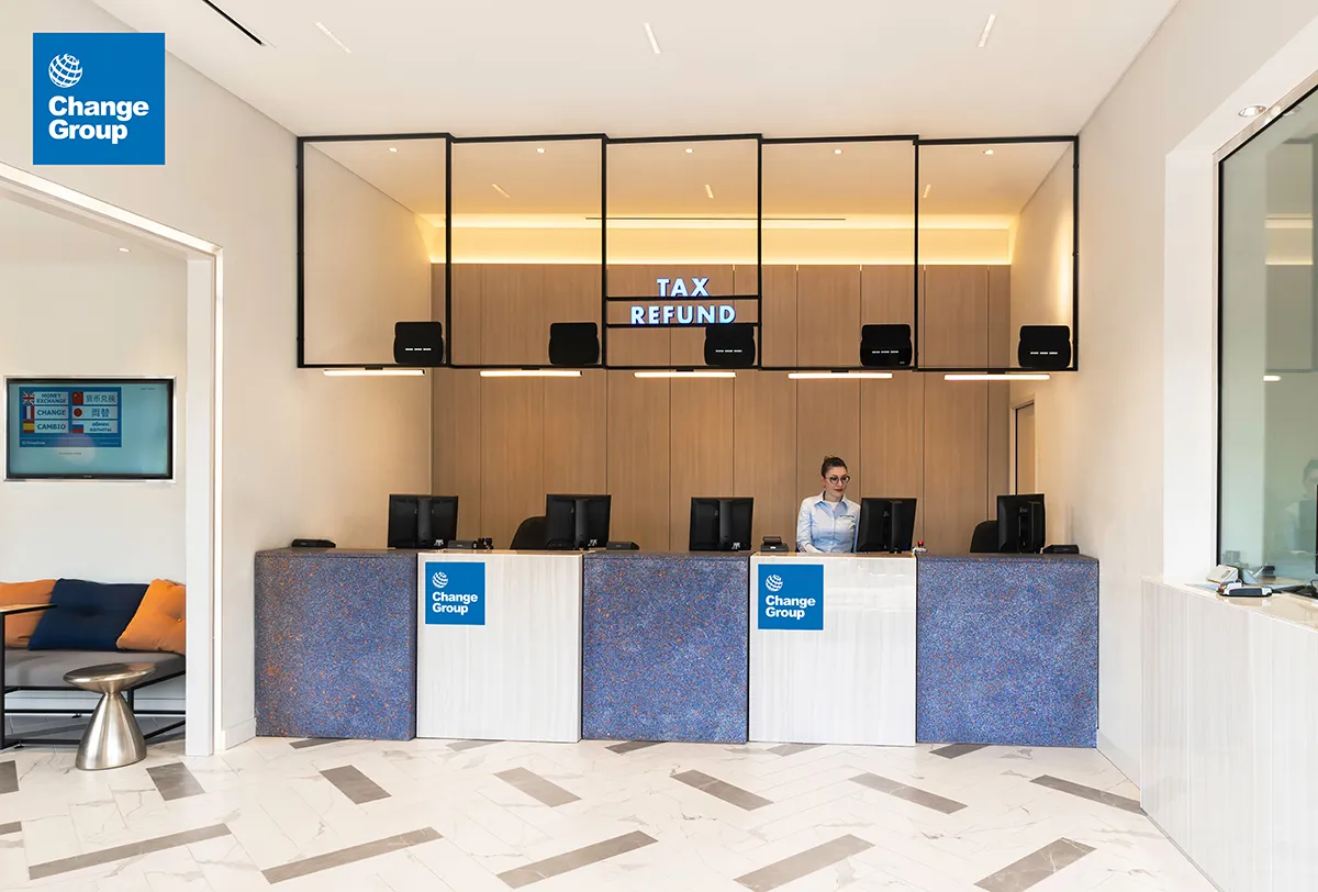 A hotel lobby featuring a reception desk, elegantly designed with modern decor and welcoming ambiance for guests.