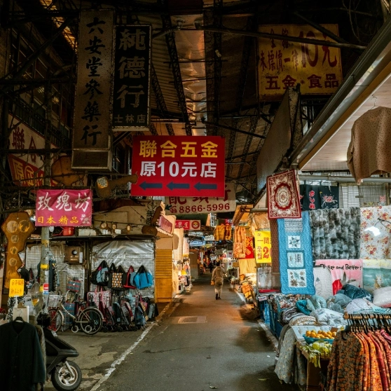 A woman taking a selfie while wearing a hat, smiling and capturing a moment of joy.
