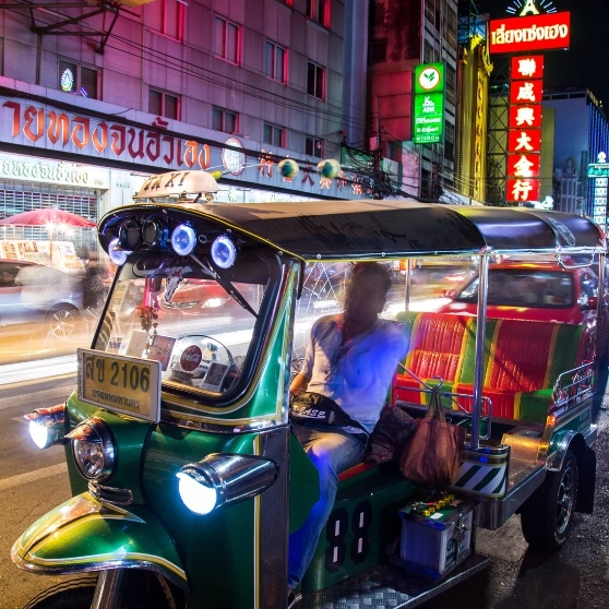 A woman taking a selfie while wearing a hat, smiling and capturing a moment of joy.
