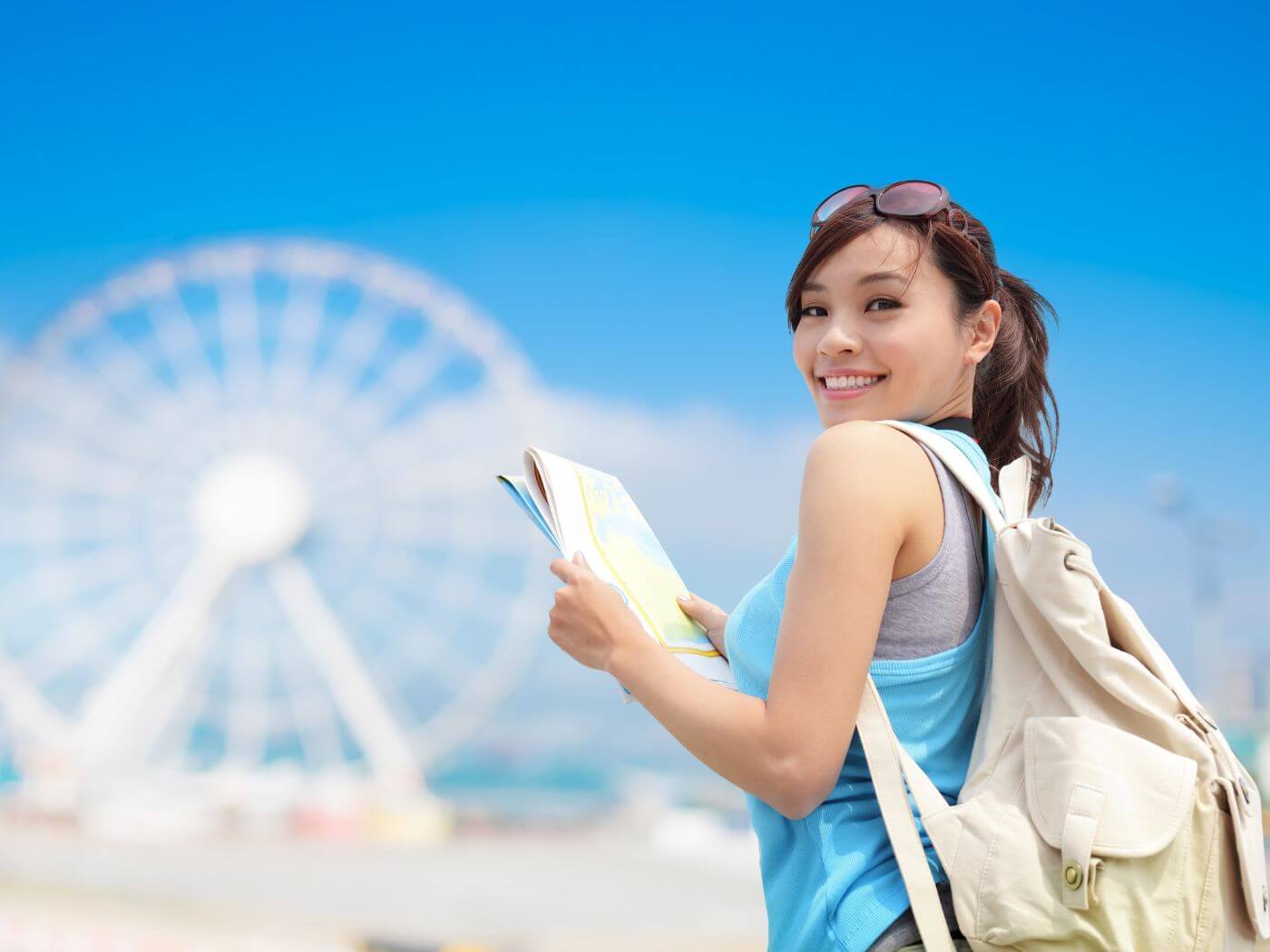 A happy woman expressing joy with the sea and mountains as background