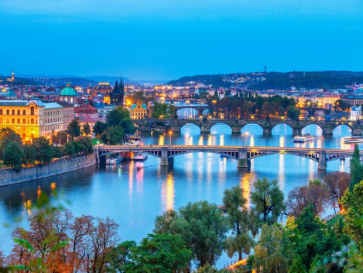 Panoramic view of Prague, Czech Republic with iconic landmarks and river.