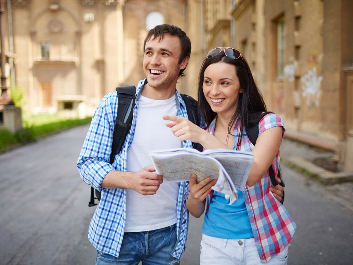 a couple roaming around a city with a map