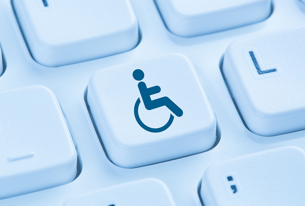 Computer keyboard with with one key highlighted with a disability symbol
